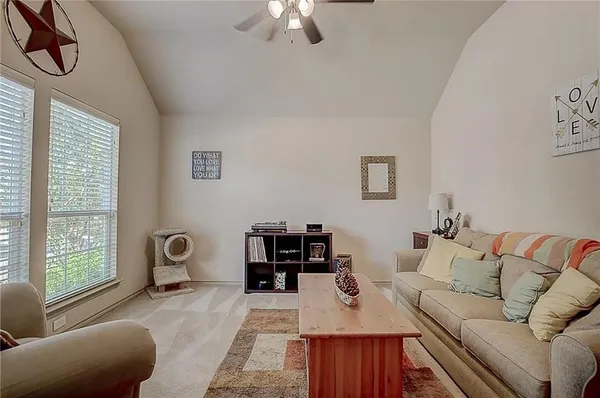 a living room with furniture and a large window