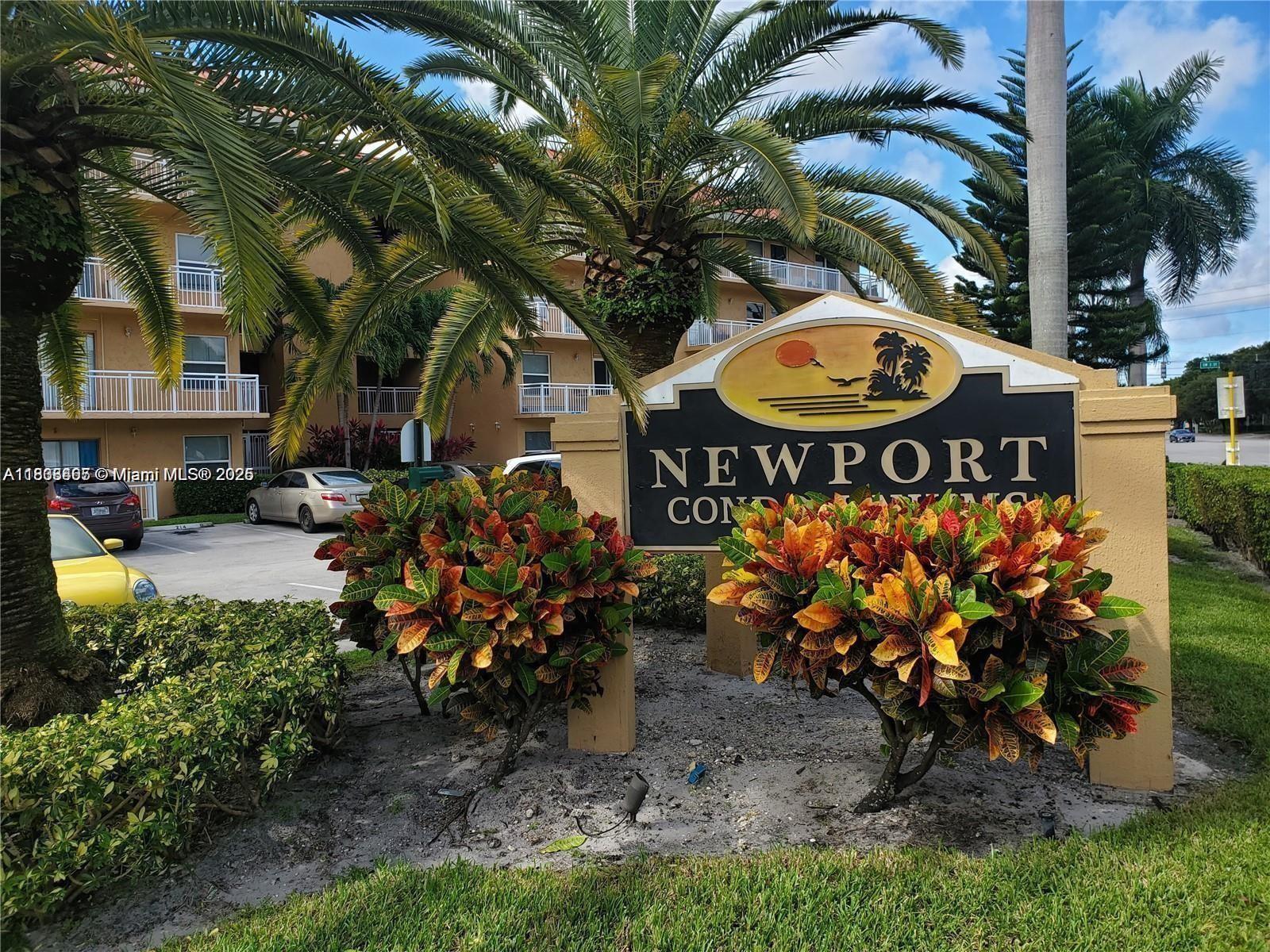 a view of a sign board with buildings