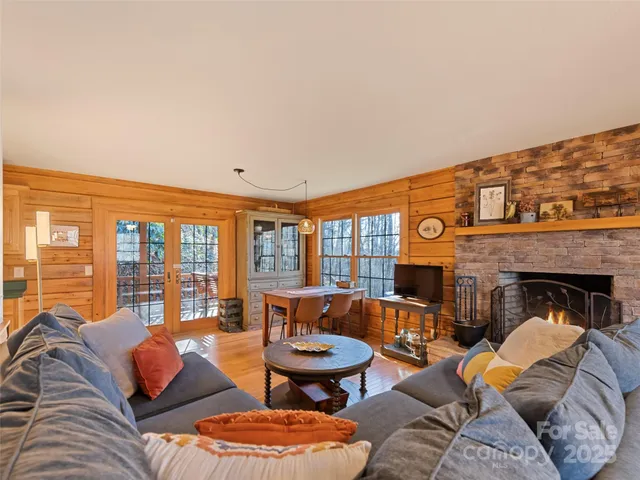 a living room with furniture a rug and a large window
