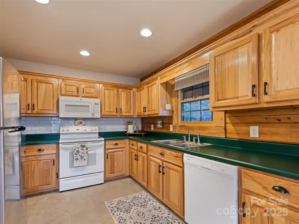 a kitchen with stainless steel appliances granite countertop a sink and cabinets