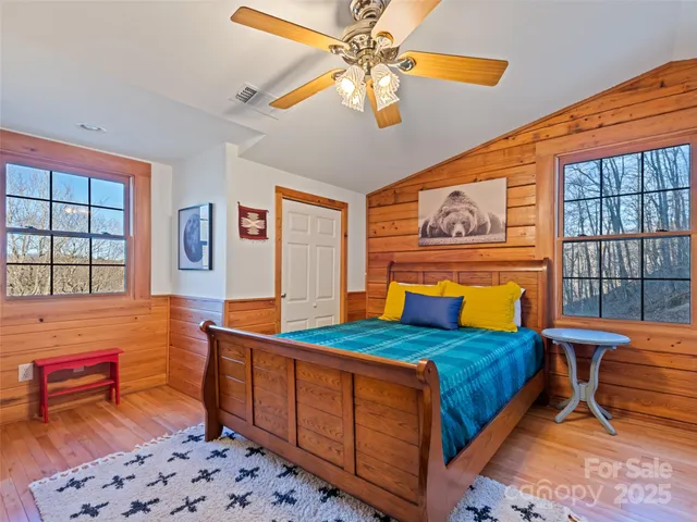 a spacious bedroom with a large bed and a chandelier