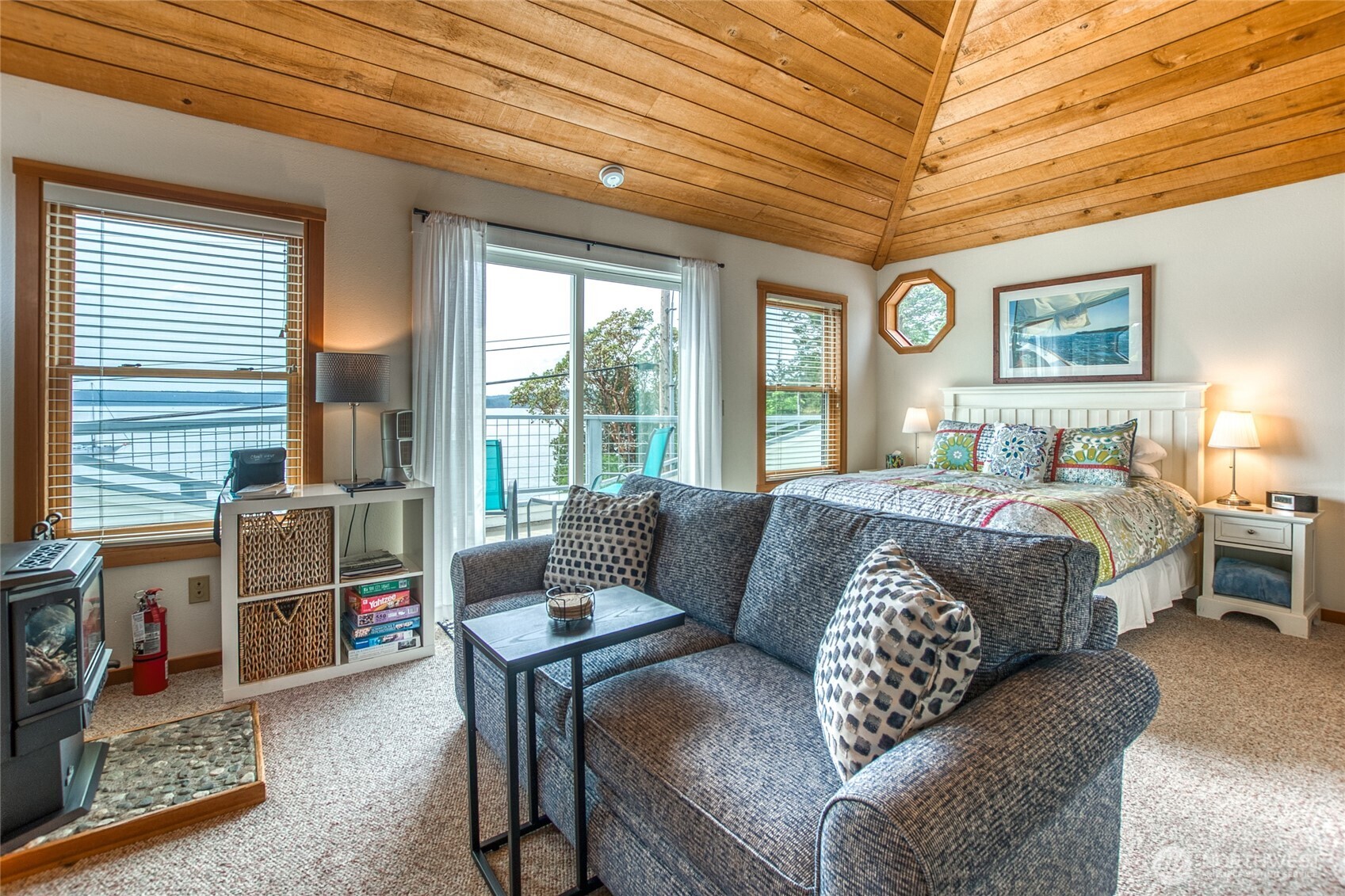 942 Deer Harbor Road Orcas Island, WA 98245 - Photo 22 of 40 a bedroom with furniture and a large window