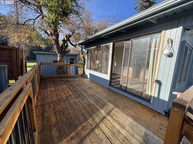 a view of a house with wooden floor and fence