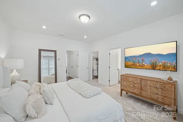 a bedroom with a bed and a large window