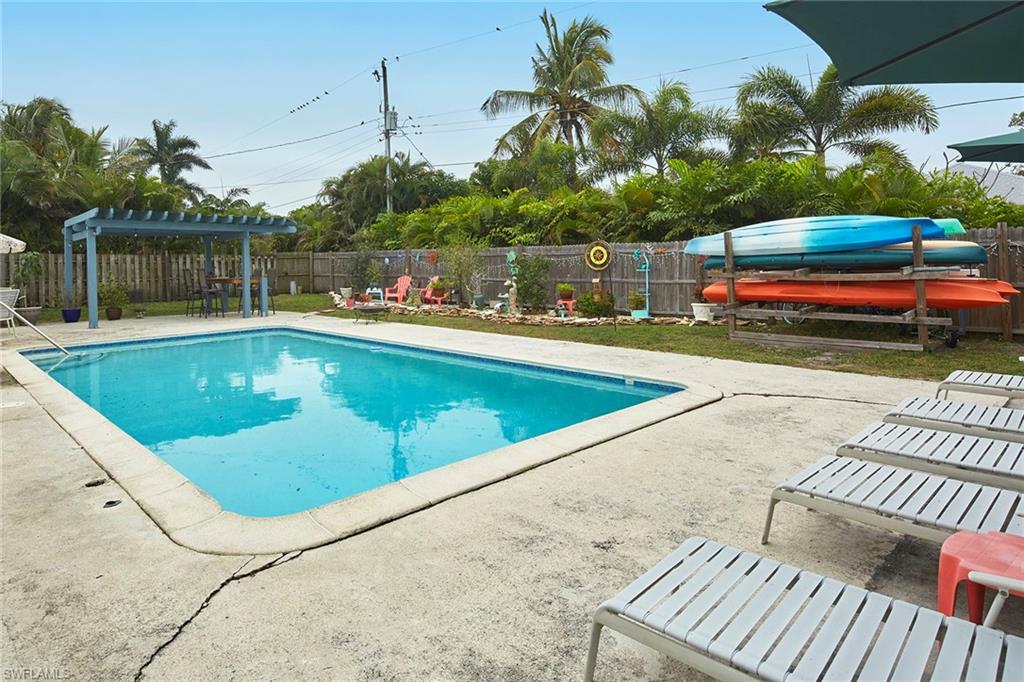 1343 12th Street North Naples, FL 34102 - Photo 12 of 18 a view of a swimming pool with a lounge chairs