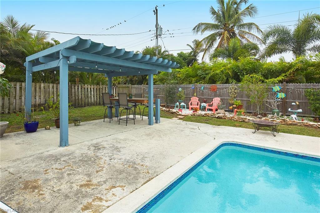 1343 12th Street North Naples, FL 34102 - Photo 13 of 18 a view of a swimming pool with lounge chair