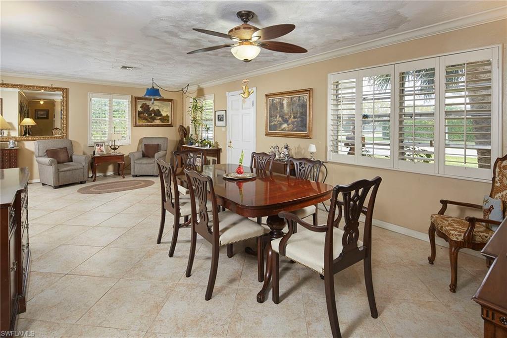 1343 12th Street North Naples, FL 34102 - Photo 4 of 18 a view of a dining room with furniture and a potted plant