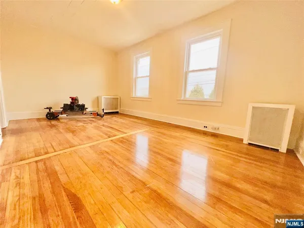 a view of a room with a wooden floor and a window
