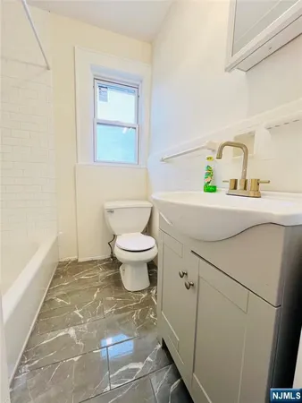 a bathroom with a sink toilet and vanity