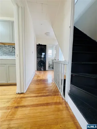 a view of entryway and hall with wooden floor