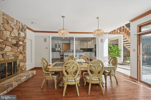 a kitchen with granite countertop a stove a sink and wooden floors