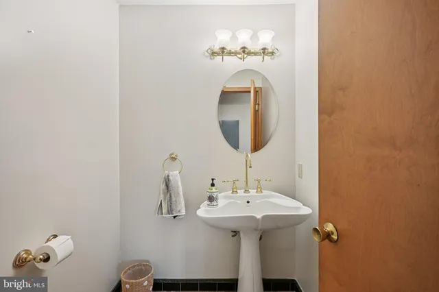 a bathroom with a sink a mirror and a toilet