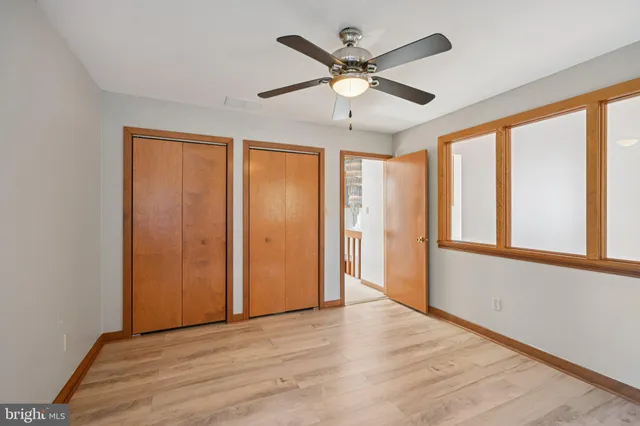 a view of a livingroom with a furniture a ceiling fan and a rug