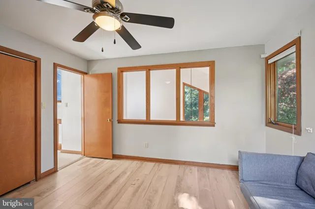 a spacious bedroom with a bed and a cabinets