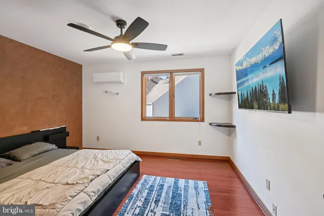 a living room with furniture a air conditioner and a window
