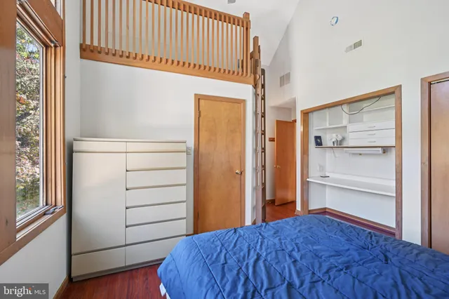 a view of a livingroom with wooden floor and a window