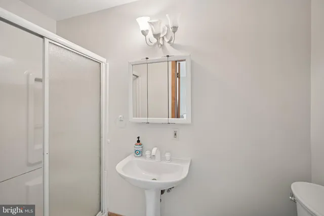 a bathroom with a toilet sink and shower