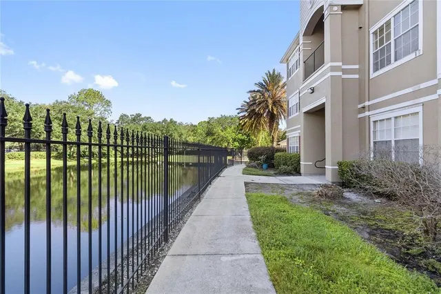 a view of a pathway with a wrought fence