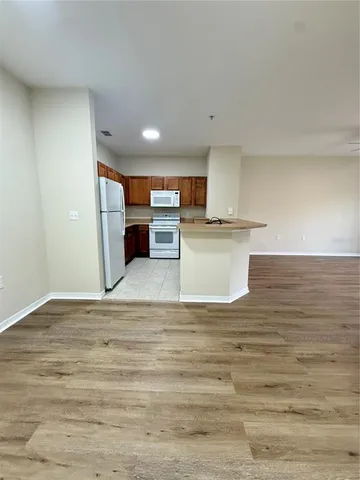 a view of a kitchen with microwave and cabinets