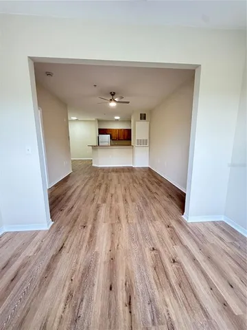 a view of empty room with wooden floor