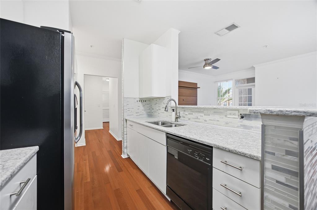4221 West Spruce Street, Unit 2328 Tampa, FL 33607 - Photo 11 of 40 a kitchen with a sink stove and refrigerator