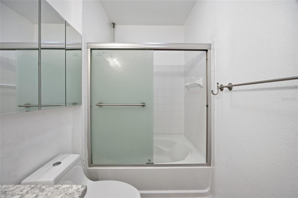 4221 West Spruce Street, Unit 2328 Tampa, FL 33607 - Photo 14 of 40 a bathroom with a bathtub and a shower