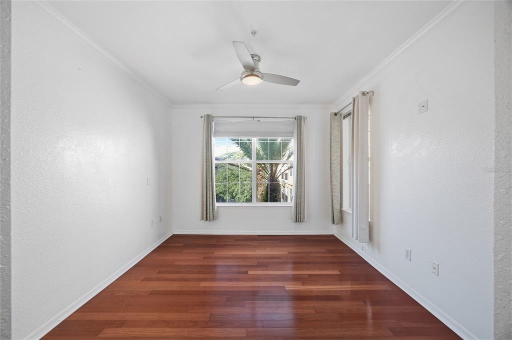 4221 West Spruce Street, Unit 2328 Tampa, FL 33607 - Photo 15 of 40 wooden floor in an empty room with a window
