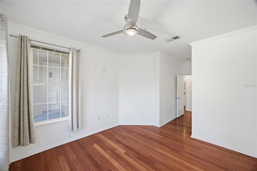 4221 West Spruce Street, Unit 2328 Tampa, FL 33607 - Photo 16 of 40 a view of a room with wooden floor and a ceiling fan