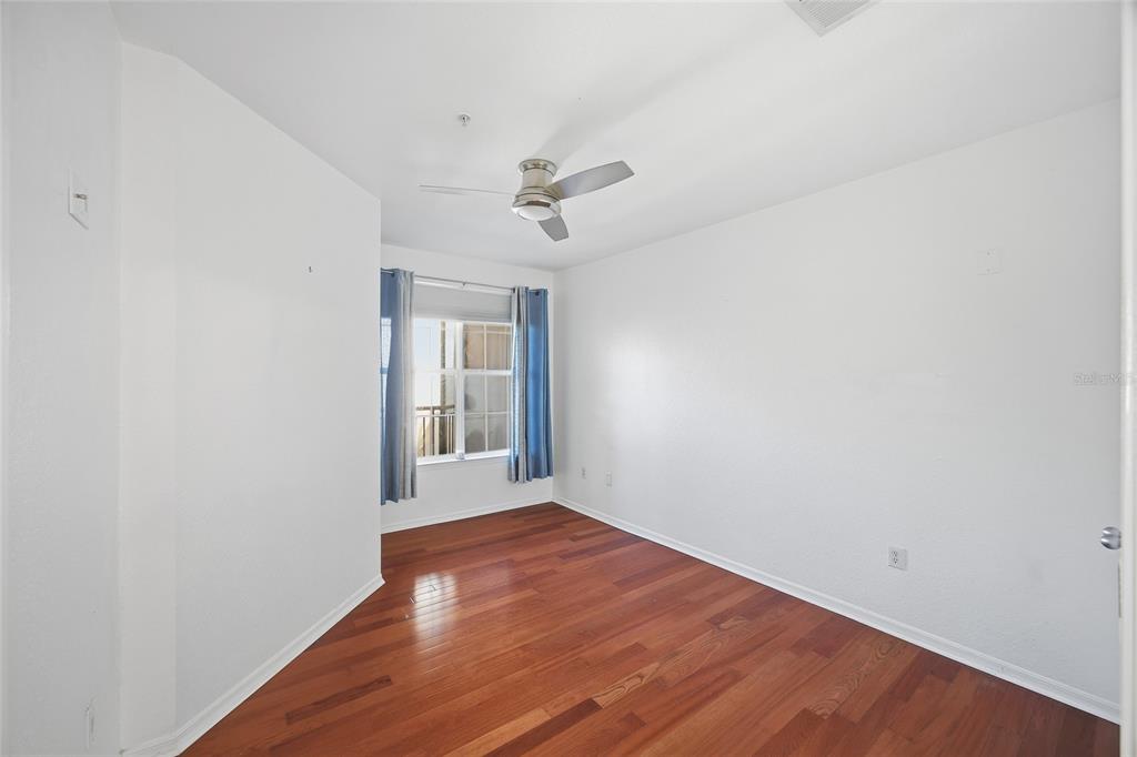 4221 West Spruce Street, Unit 2328 Tampa, FL 33607 - Photo 18 of 40 wooden floor in an empty room with a window