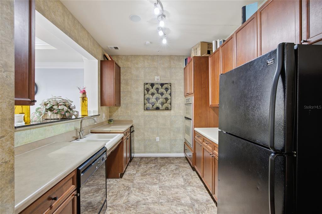 4221 West Spruce Street, Unit 2328 Tampa, FL 33607 - Photo 28 of 40 a kitchen with stainless steel appliances a refrigerator and a sink