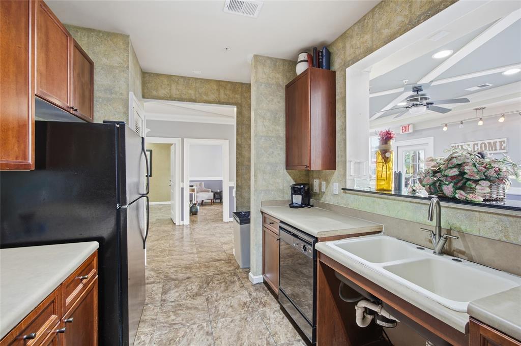 4221 West Spruce Street, Unit 2328 Tampa, FL 33607 - Photo 29 of 40 a kitchen with a sink stove and refrigerator