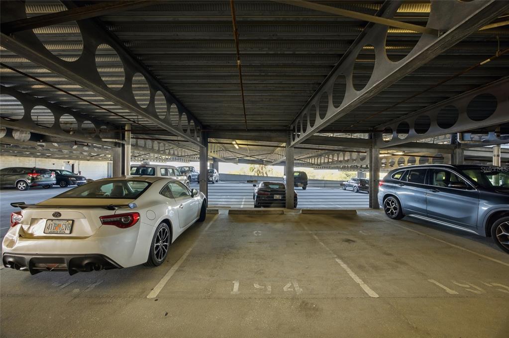 4221 West Spruce Street, Unit 2328 Tampa, FL 33607 - Photo 32 of 40 a view of parking garage with cars