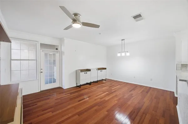 a view of a kitchen with wooden floor and a sink