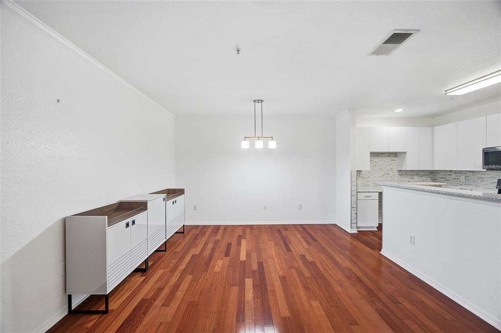 4221 West Spruce Street, Unit 2328 Tampa, FL 33607 - Photo 9 of 40 a view of a kitchen with wooden floor and a sink