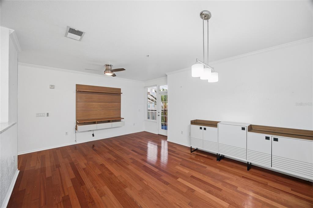 4221 West Spruce Street, Unit 2328 Tampa, FL 33607 - Photo 10 of 40 a view of a room with wooden floor and flat screen tv
