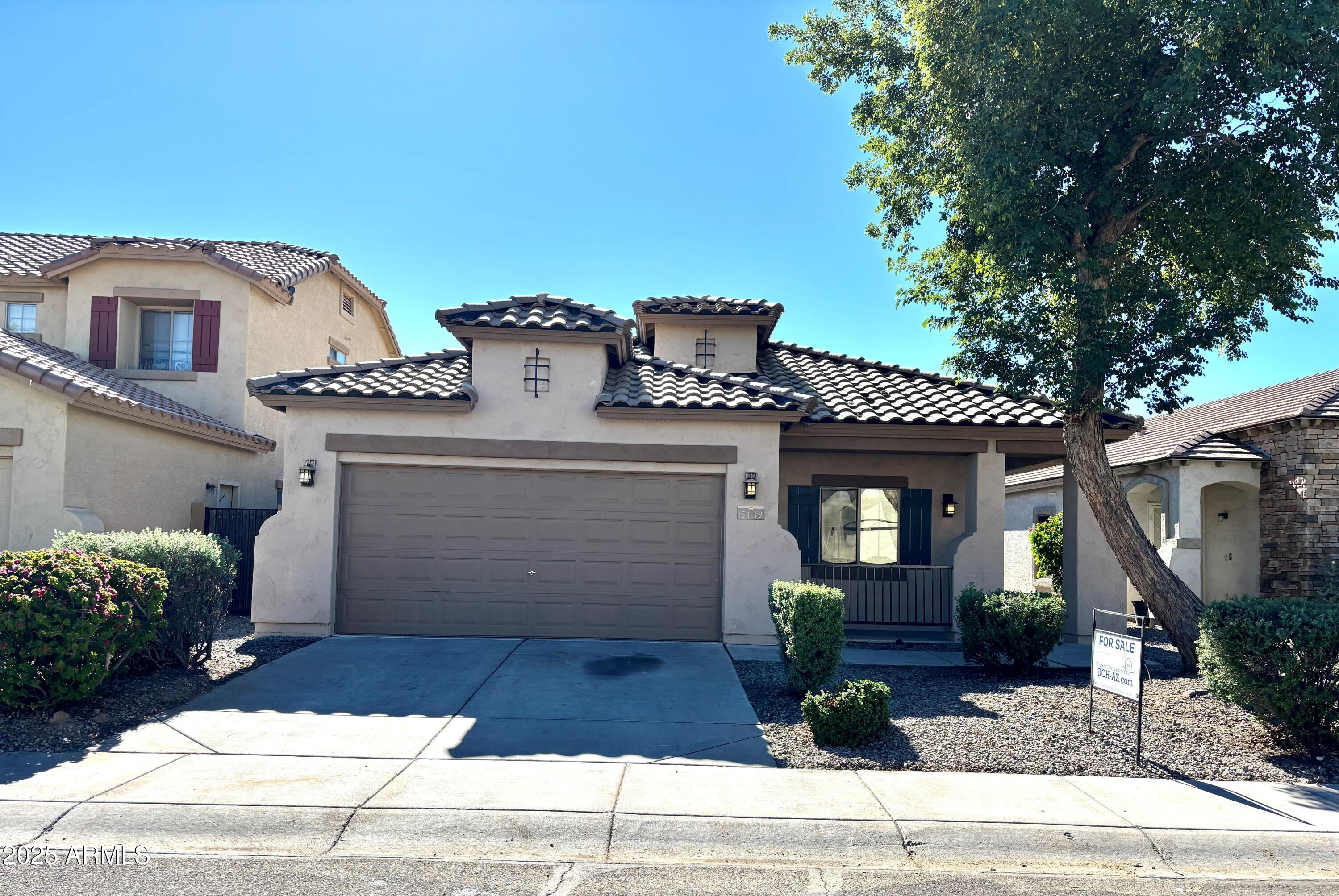 5139 West Maldonado Road Laveen, AZ 85339 - Photo 1 of 39 a front view of a house with garden