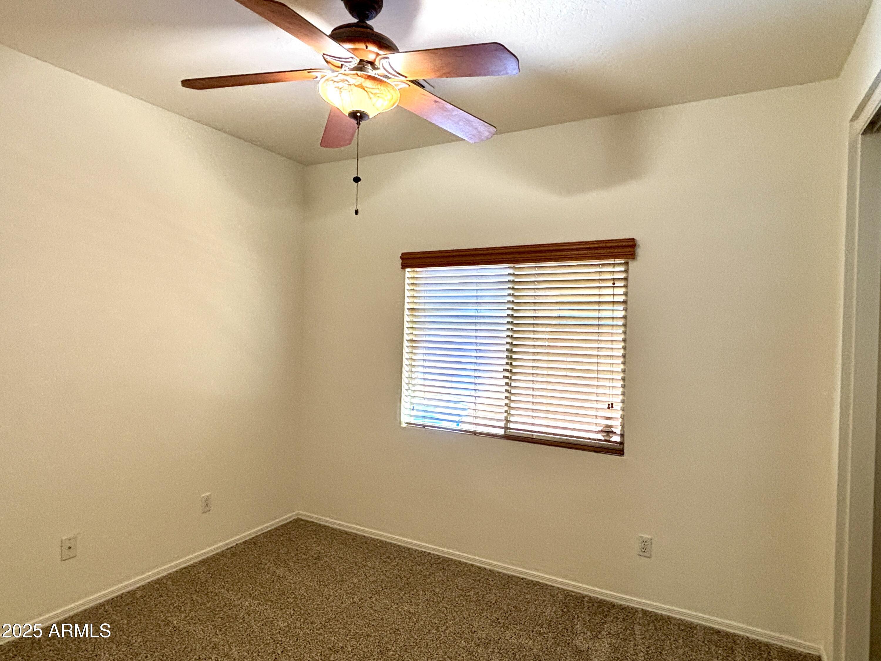 5139 West Maldonado Road Laveen, AZ 85339 - Photo 24 of 39 an empty room with a window and a fan