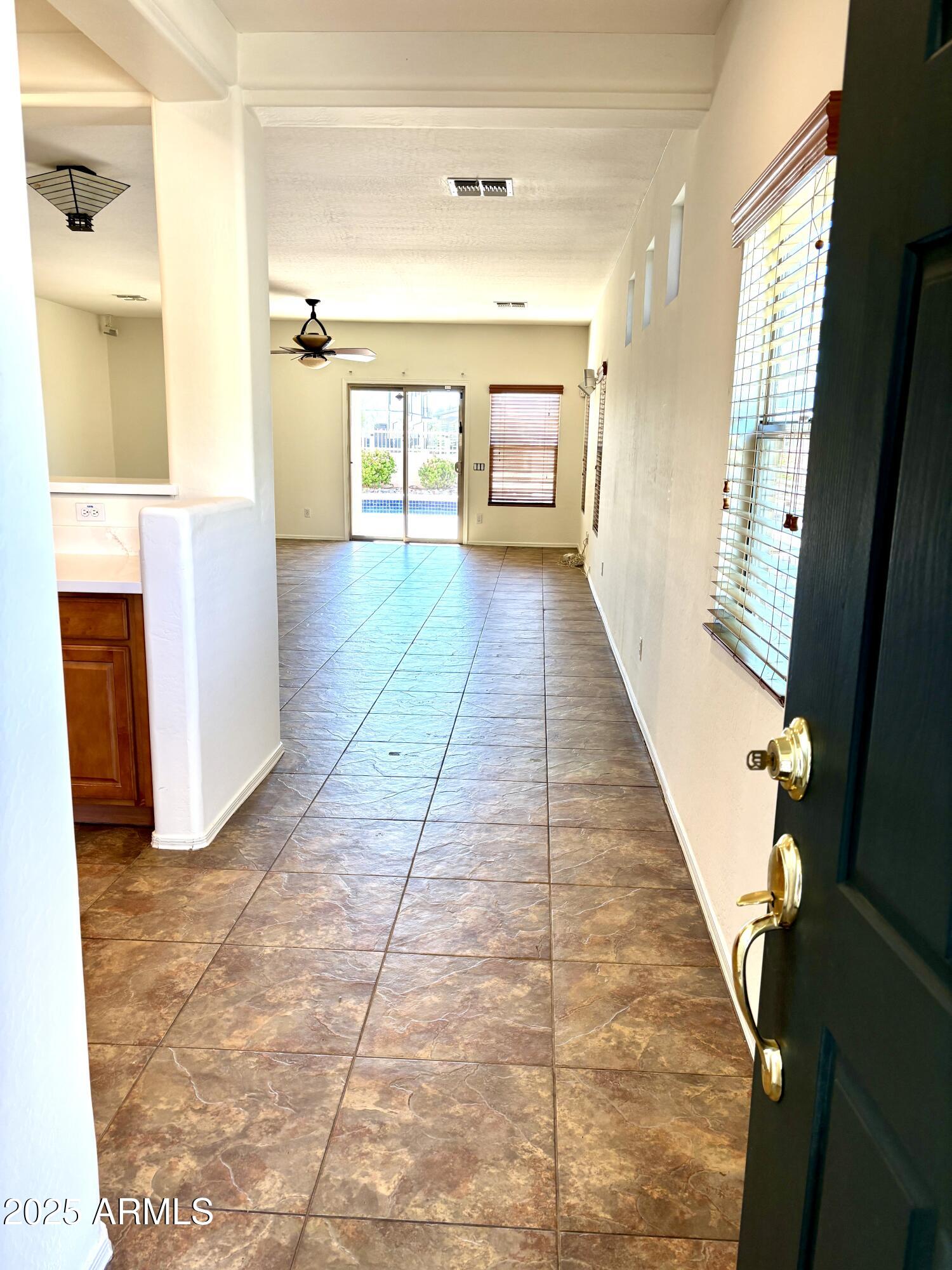 5139 West Maldonado Road Laveen, AZ 85339 - Photo 3 of 39 a view of a hallway with a dining table & chairs