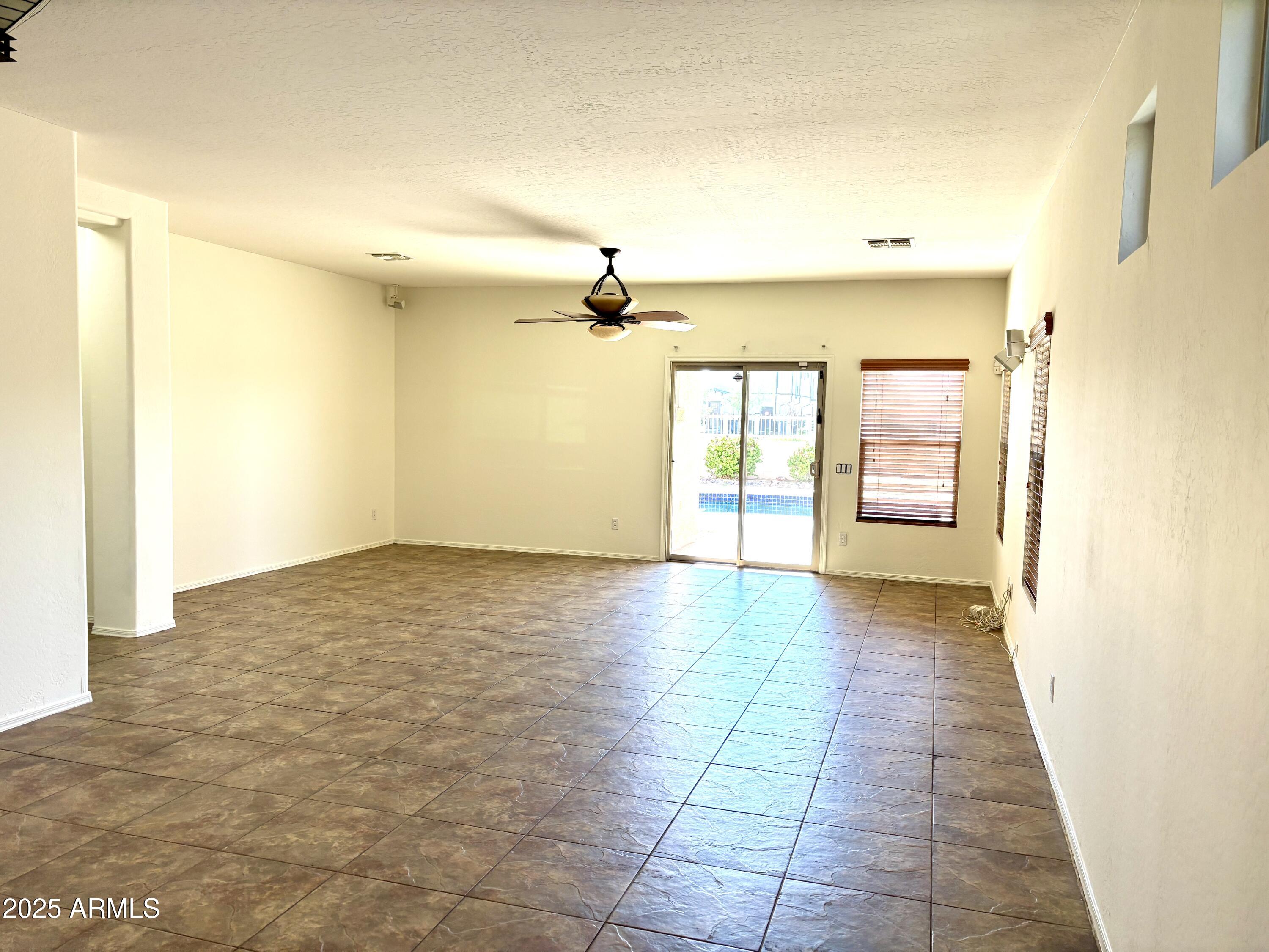 5139 West Maldonado Road Laveen, AZ 85339 - Photo 5 of 39 wooden floor in an empty room with a window