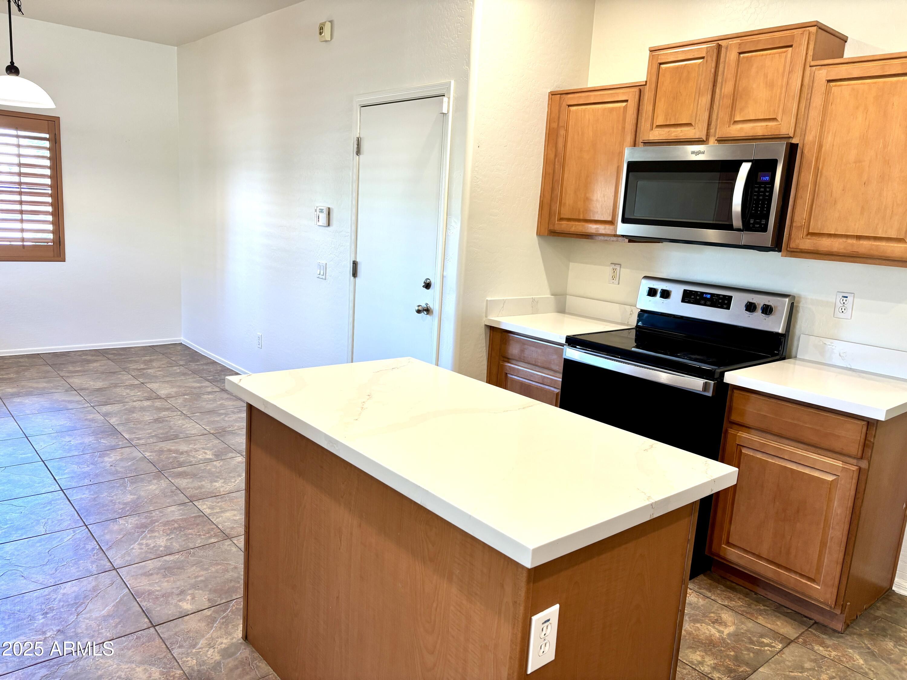 5139 West Maldonado Road Laveen, AZ 85339 - Photo 9 of 39 a kitchen that has a sink and a stove in it
