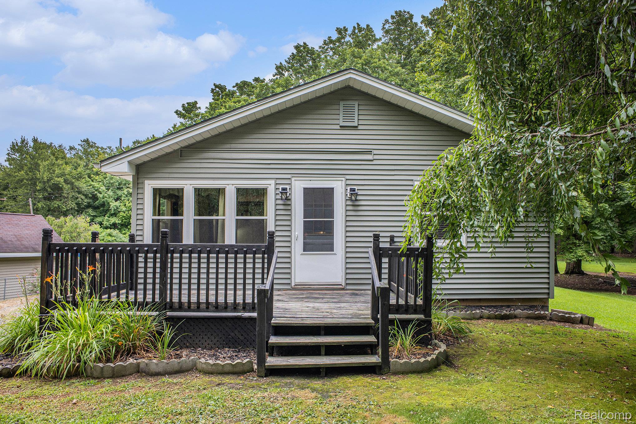 16568 28 Mile Road Albion, MI 49224 - Photo 1 of 26 View of front of property featuring a front yard and a deck