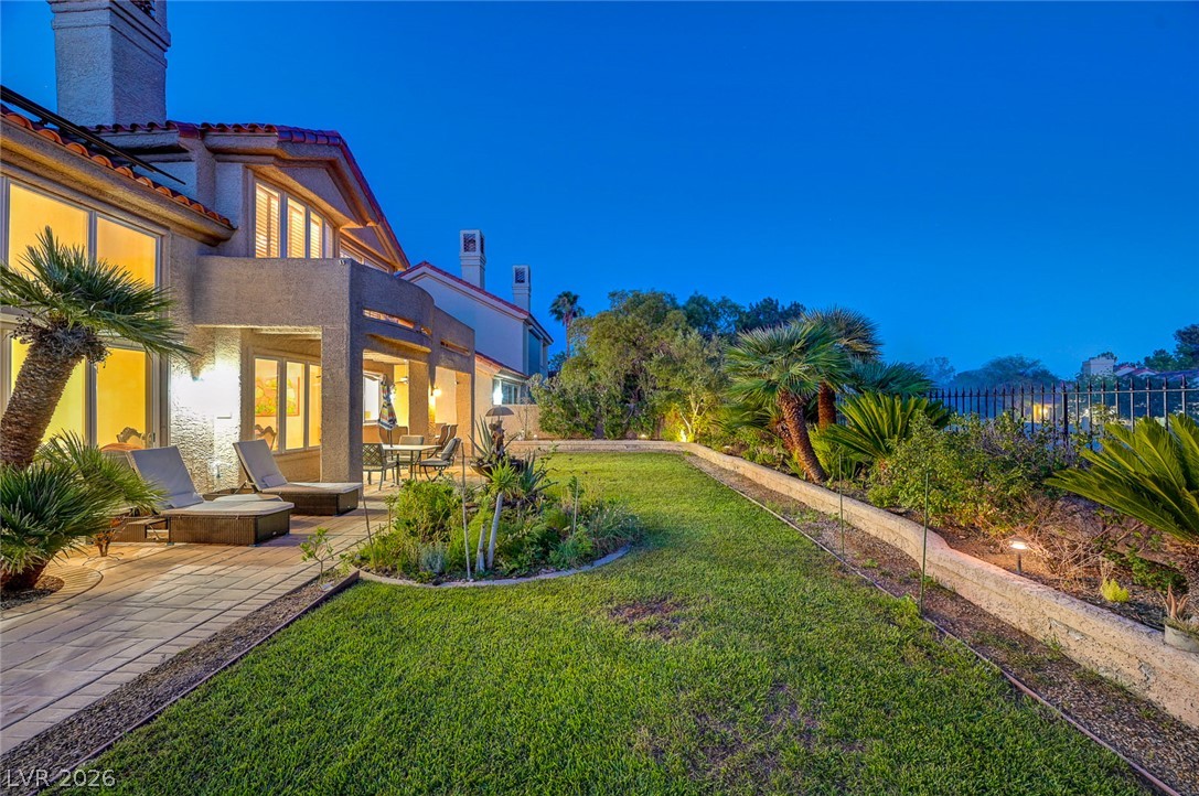 7995 Rio Rico Drive Las Vegas, NV 89113 - Photo 69 of 92 Lush landscaping and ample patio space create an inviting outdoor oasis for relaxation and entertainment.