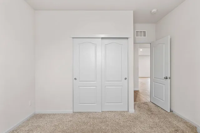 an empty room with closet area