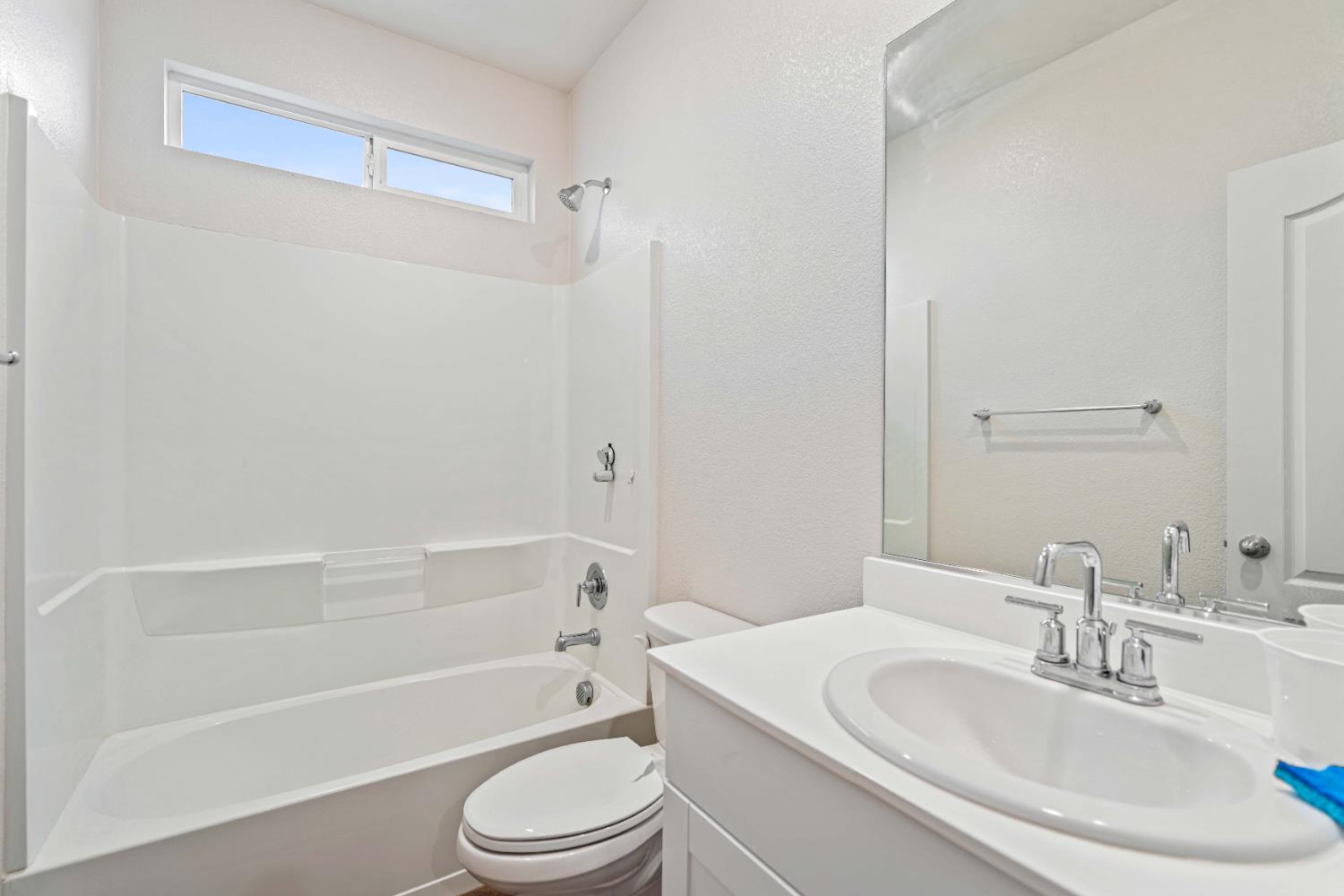 3095 Tower Street Manteca, CA 95337 - Photo 14 of 40 a bathroom with a toilet a sink and a bathtub
