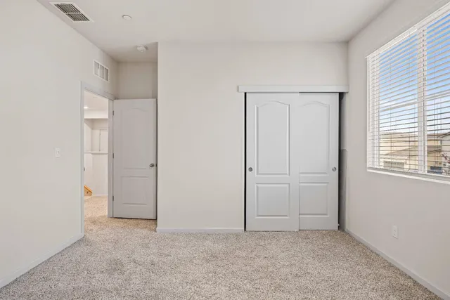 an empty room with windows and closet