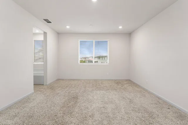 an empty room with a windows and closet