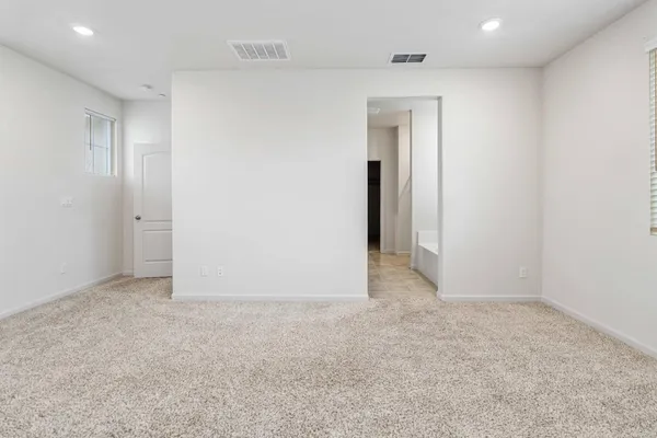 an empty room with closet and a bathroom