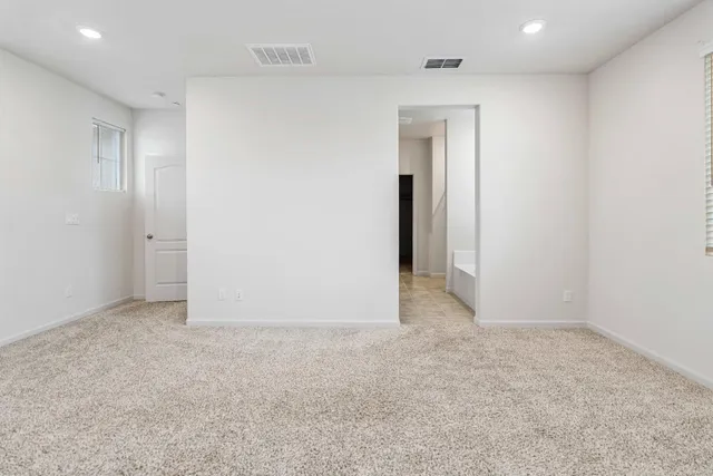 an empty room with closet and a bathroom