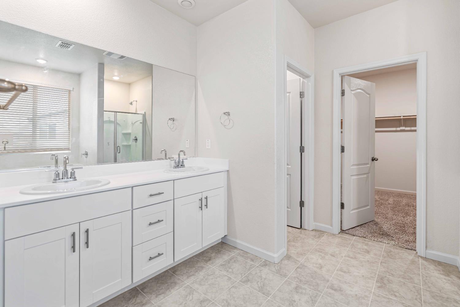 3095 Tower Street Manteca, CA 95337 - Photo 26 of 40 a spacious bathroom with double sink and a mirror