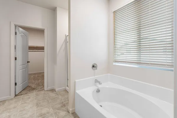 a white bath tub sitting next to a small yard
